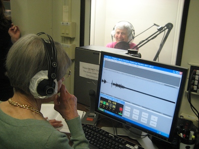Picture of a team recording in a booth at the Library.
