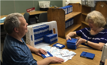 Volunteers sort through tapes